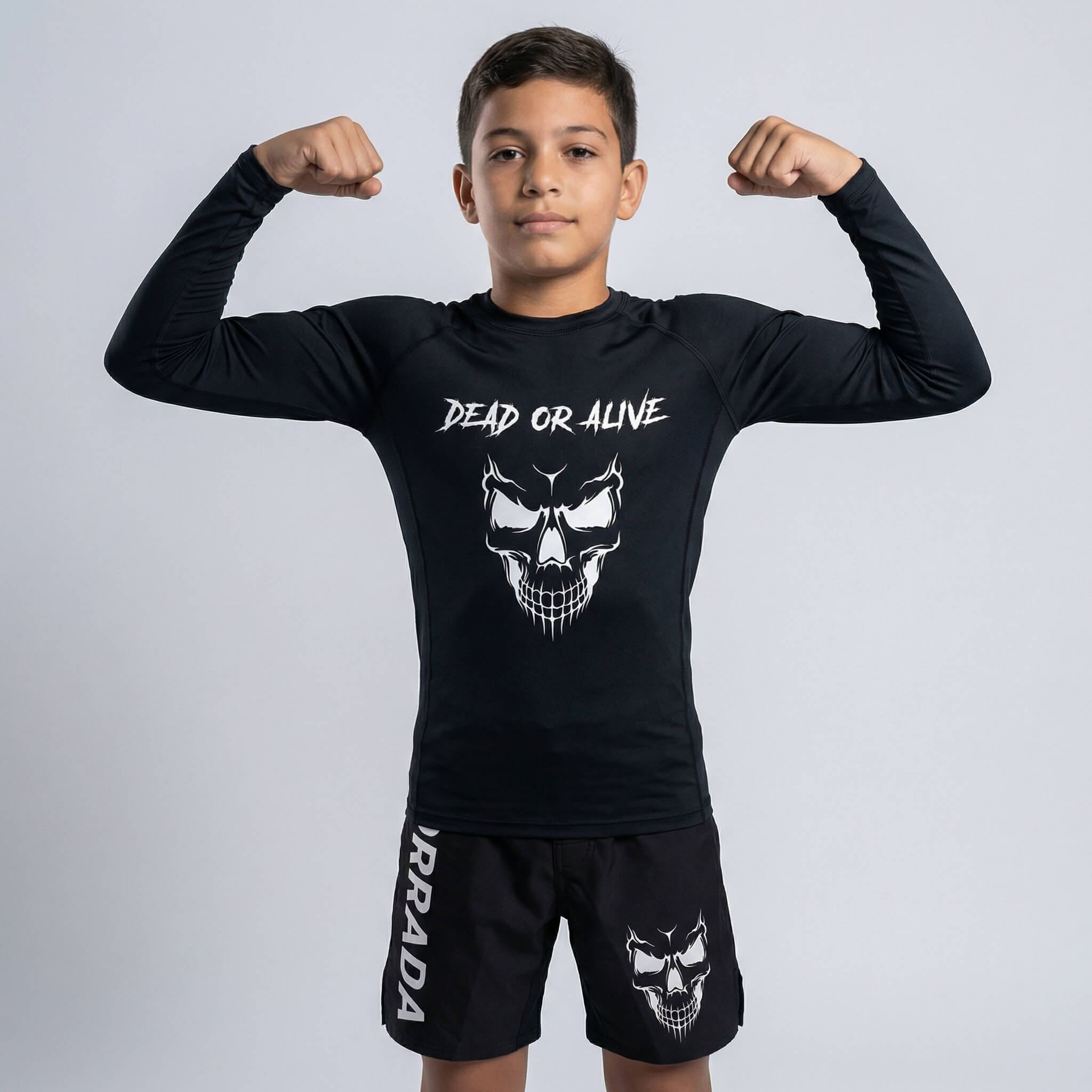 Kids’ black long-sleeve rash guard featuring a ‘Dead or Alive’ skull design, perfect for BJJ and MMA training