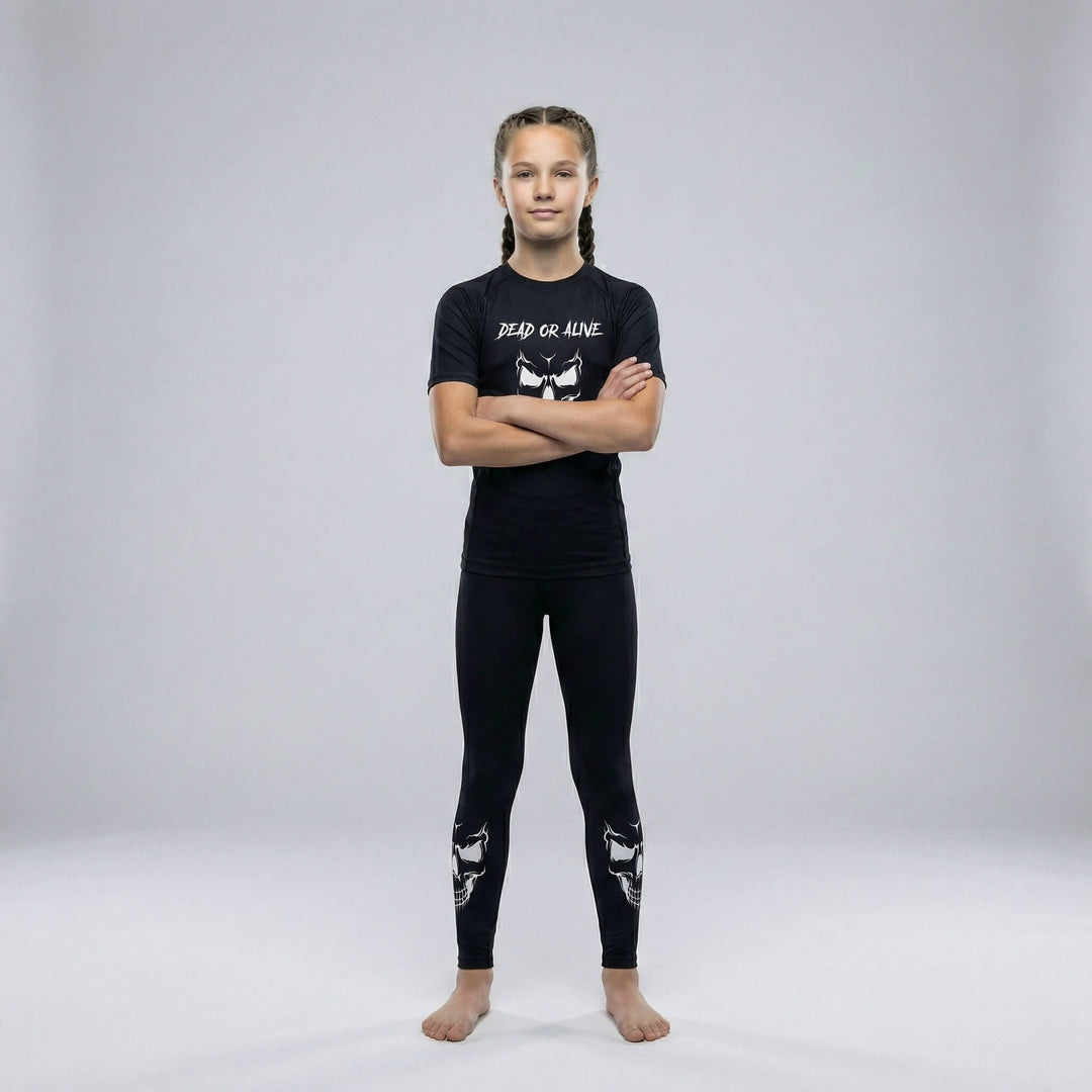 Kids’ grappling spats in black with a ‘Dead or Alive’ skull graphic for martial arts practice