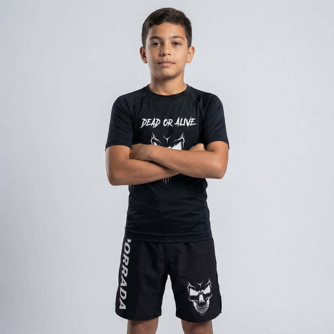 Kids' black fight shorts with a fierce skull graphic for MMA and BJJ training