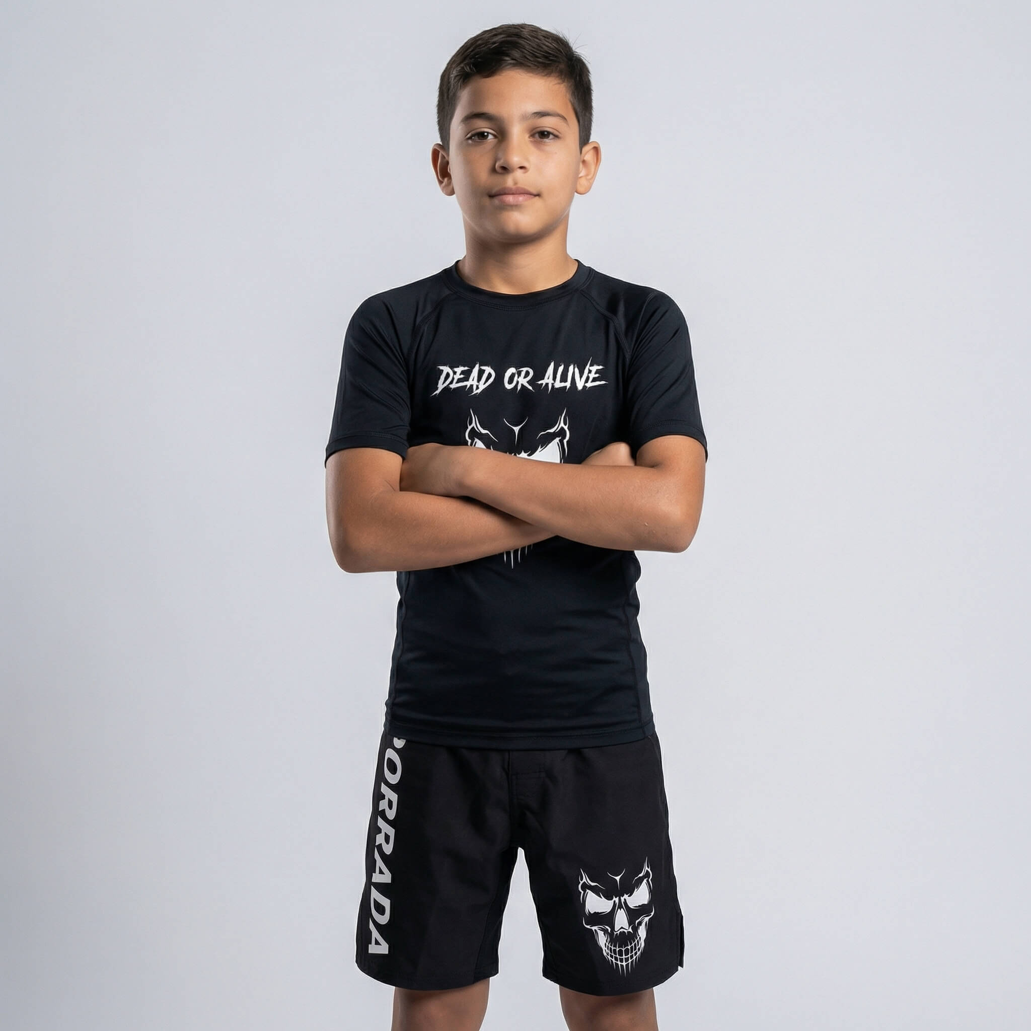 Kids' black fight shorts with a fierce skull graphic for MMA and BJJ training