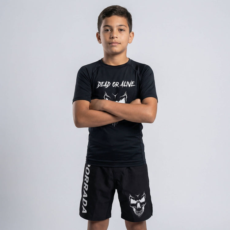 Kids' black fight shorts with a fierce skull graphic for MMA and BJJ training