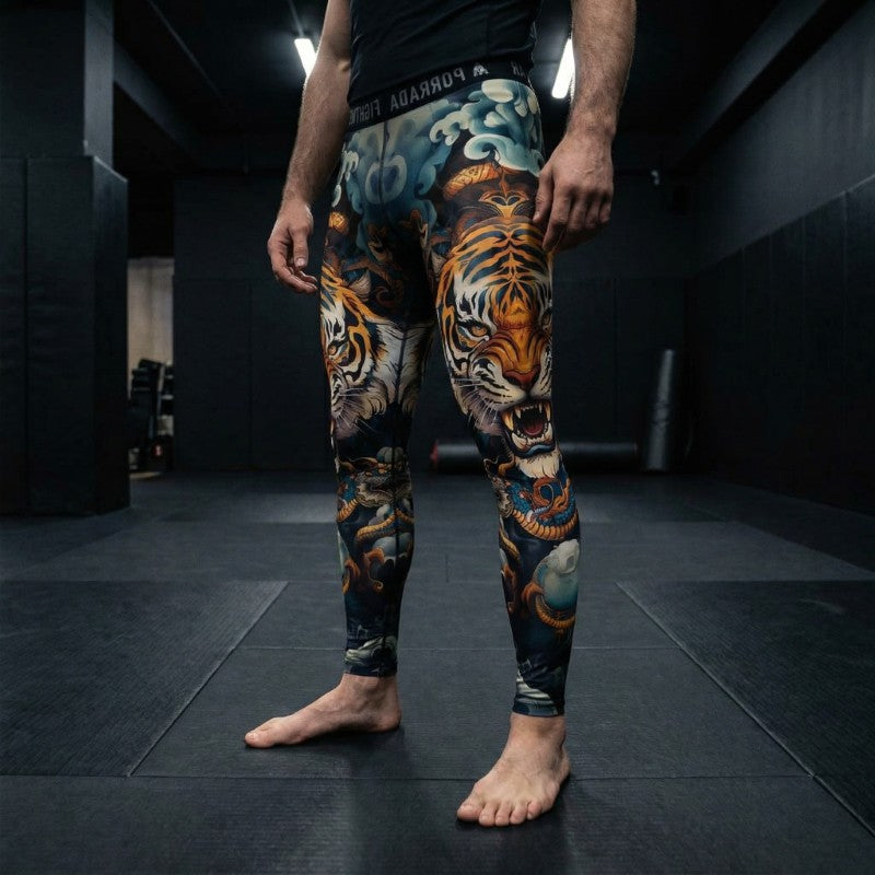 Male grappling athlete wearing Porrada Fightwear men’s BJJ spats with tiger design while training in a MMA gym.